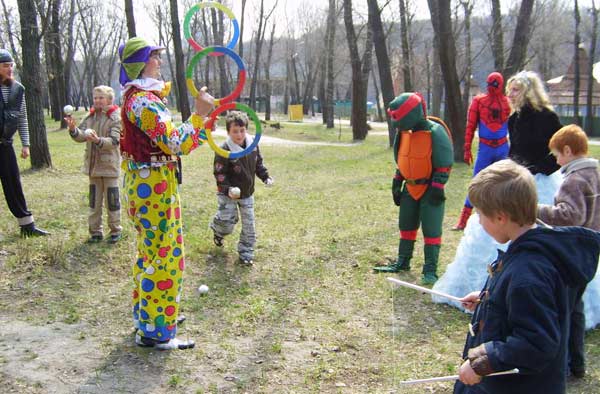 дети и клоун учатся жонглировать